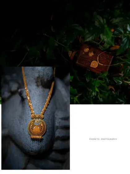 An artistic still-life of the bride's traditional gold necklace and other wedding details, captured with a creative eye.