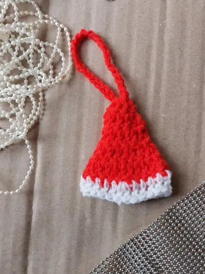A tiny crochet Santa hat ornament. These are adorable and can be ordered in bulk for Christmas party favors.