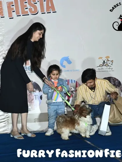 A young pet parent and her family celebrating their win on stage. My events are designed to be family-friendly, with a welcoming atmosphere for everyone.