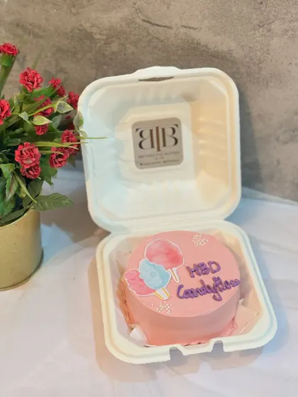 A "HBD Candyfloss" bento cake with cute cotton candy illustrations.