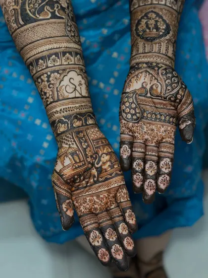 For this bride, we incorporated traditional wedding elements like elephants and palanquins, along with the couple's initials, to create a classic yet personalized bridal design.