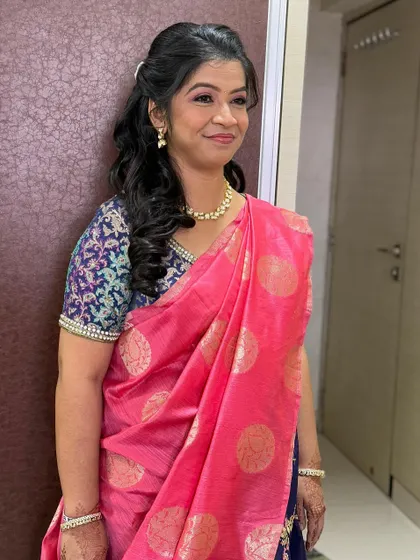 The full look, featuring a beautiful pink and blue saree. The makeup is timeless and complements her traditional attire perfectly.