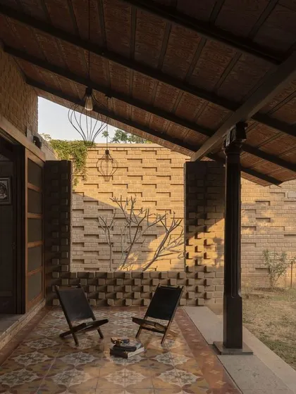 Another view of the verandah, supported by restored wooden columns from old houses in Tamil Nadu, which brings a sense of history and heritage to the design.