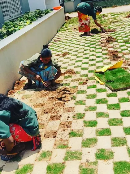 Our team is meticulously installing checkerboard turf pavers. This technique combines the durability of pavers with the natural beauty of grass, creating a functional and visually interesting surface for driveways and walkways.