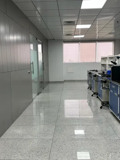 A view of the completed first floor of a commercial project in Ambala City. The design features clean lines, glass partitions for transparency, and a durable, polished tile floor suitable for high-traffic areas.