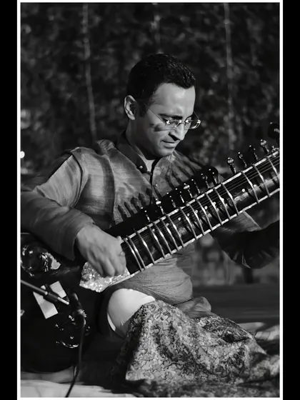 A focused black and white shot from an outdoor evening concert.
