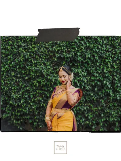 A full-length portrait of the bride against a wall of green leaves, a simple yet elegant shot that emphasizes her beauty.