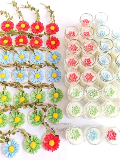 An assortment of colorful daisy wax sachets and succulent-topped jar candles, showcasing the variety within a single birthday order.