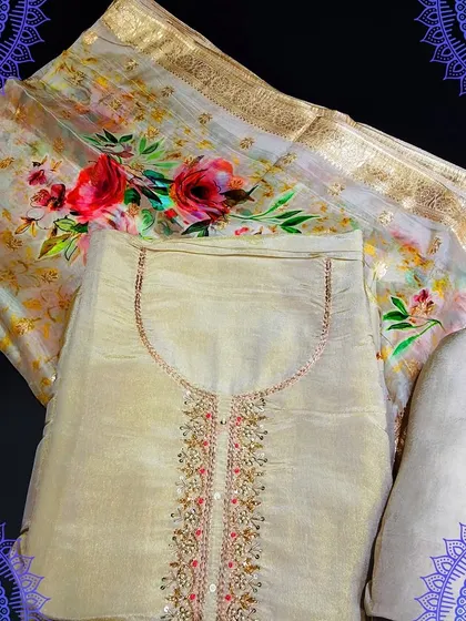An elegant beige dress material with a digitally printed floral dupatta. The top has delicate embroidery around the neckline, making it a perfect choice for a subtle yet festive look.