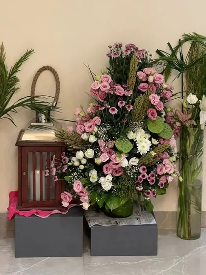 Floral arrangements never disappoint. This large, lush arrangement of pink and white roses serves as a stunning statement piece for an entryway or console table, welcoming guests with beauty.