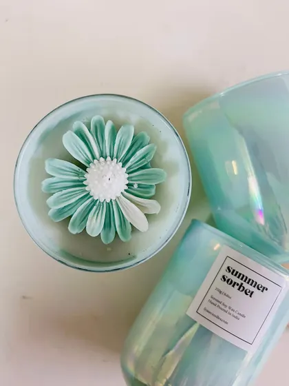 Summer is here, and we have the best jars to refresh your home. A top-down view of our 'Summer Sorbet' flower candle.