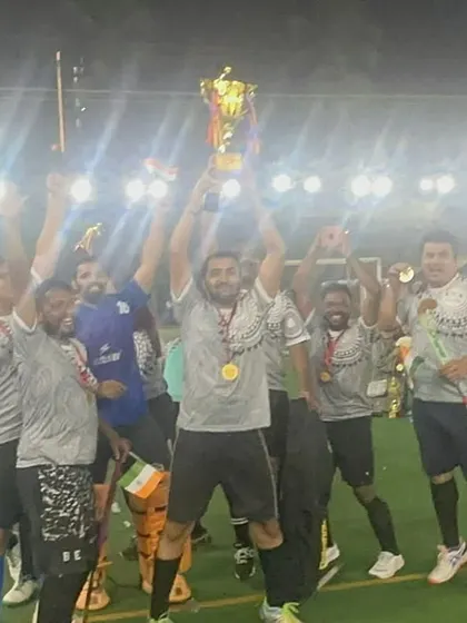 The thrill of victory! A team lifts their championship trophy high in the air, celebrating a well-deserved win under the stadium lights.
