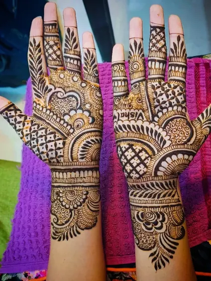 I carefully write the name of the groom, in this case 'Vishal', into the palm so it becomes a hidden gem within the intricate pattern.