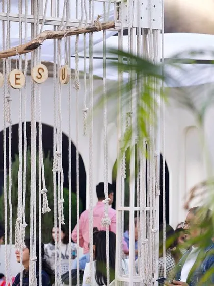 A lively shot of the Cafe Tesu pop-up with guests enjoying the space. The design, including the hanging rope details and open archways, created a popular and photogenic spot at the India Art Fair.