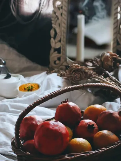 A moody still life featuring a basket of pomegranates and oranges. This shot was styled for Ramadan, using fruits that are both healthy and symbolic, creating a rich and atmospheric scene.