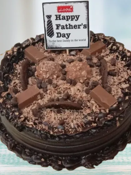 For the ultimate chocolate lover, this Father's Day chocolate overload cake is pure indulgence. It's a rich chocolate cake covered in chocolate shavings, Ferrero Rocher chocolates, and pieces of KitKat, creating a variety of textures and decadent flavors.