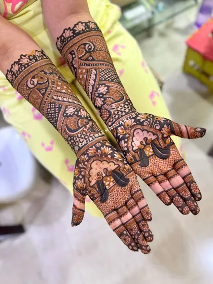 A gorgeous bridal design featuring the 'doli' (palanquin) motif, symbolizing the bride's journey to her new home, surrounded by intricate patterns.