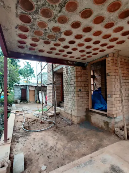 This is an in-progress shot of a load-bearing structure, featuring a filler slab roof with clay pots to reduce concrete usage.