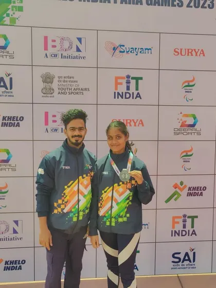 Gangavva with her coach, holding her silver medal from the Khelo India Para Games 2023 for javelin throw in the T12 category.