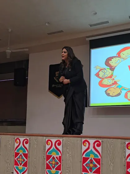 On stage at Mount Olympus School, presenting on the POCSO Act. The presentation behind me is designed to be visual and easy to understand, breaking down complex legal concepts for a young audience.
