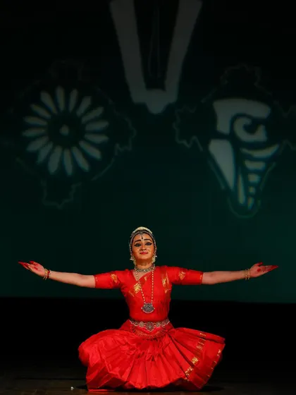 A pose of offering and welcome, with arms outstretched. This moment signifies the devotee's complete surrender and acceptance at the feet of the Lord.