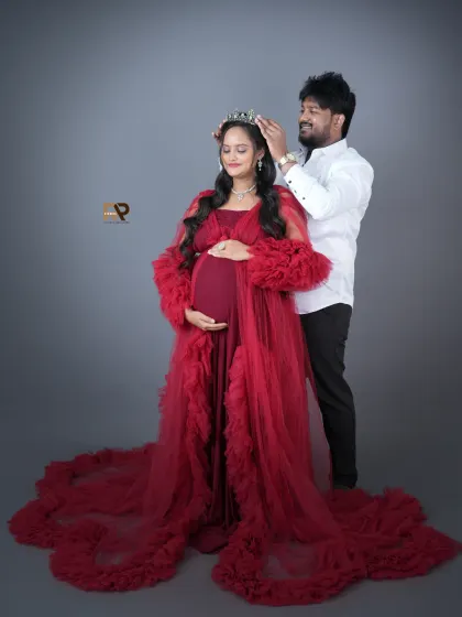 Crowning the queen. A beautiful moment as the dad-to-be places a crown on his partner's head, celebrating her strength and grace during the pregnancy journey.