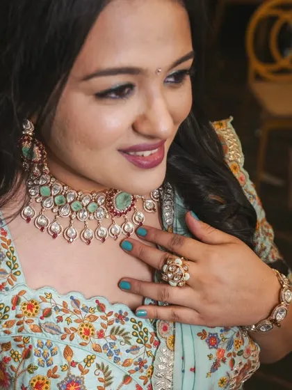 A real client looking beautiful in a floral printed light blue lehenga, a perfect rental for a day event or a destination wedding.