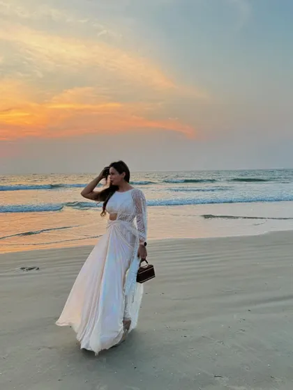Walking on the beach in a flowy white saree, feeling the Bollywood magic. I love to fully embrace the theme of a destination wedding, both in my hosting and my style.