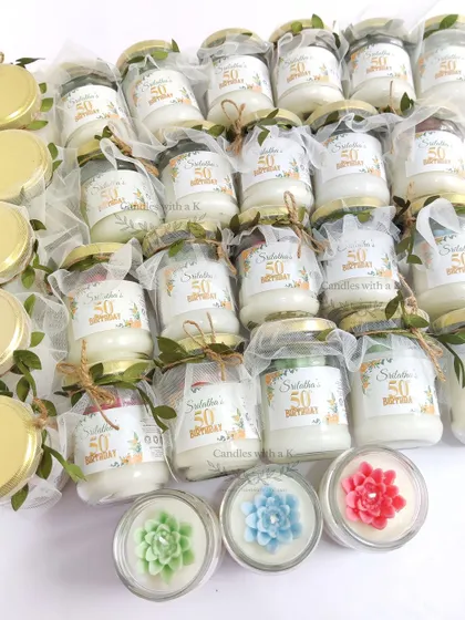 The final packaged 100ml jar candles with succulent tops, personalized for a 50th birthday, ready to be gifted.