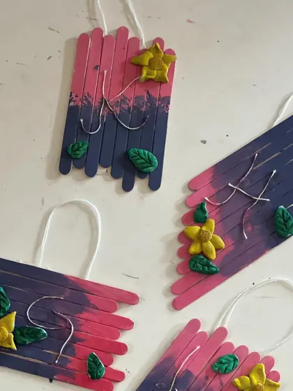 The finished popsicle stick wall hangings, decorated with clay flowers and leaves. A beautiful, multi-media project.