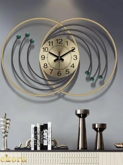 A creative wall clock with interlocking gold and black rings, creating a sense of movement and modern elegance.