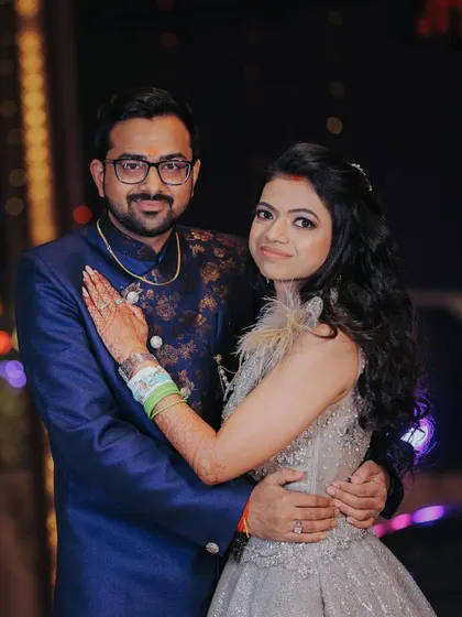 A classic portrait of the couple from their engagement night. Their coordinated outfits and happy smiles make for a perfect memory.