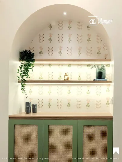 An arched niche with green cane cabinetry and subtle wallpaper, featured in The Architect's Diary. This showcases my ability to create beautiful, functional storage in unexpected places.