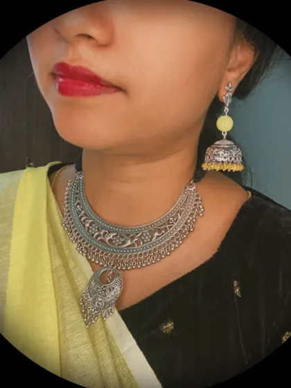 A complete look from my yellow-themed festive series. This features an oxidised silver choker necklace and matching yellow jhumkas, styled with a yellow and black saree.