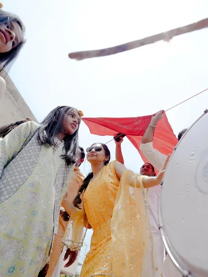 Capturing the vibrant procession and dance during the Haldi ceremony, showing the lively atmosphere of the event.