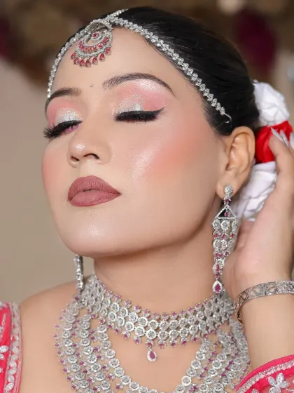 A serene shot with eyes closed, highlighting the beautiful eyeshadow work.