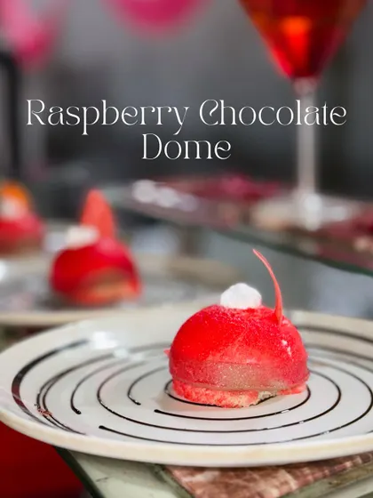 A closer look at the Raspberry Chocolate Dome. This dessert features a soft sponge base, a rich Nutella chocolate mousse center, and a vibrant raspberry coating for a perfect balance of sweet and tangy.