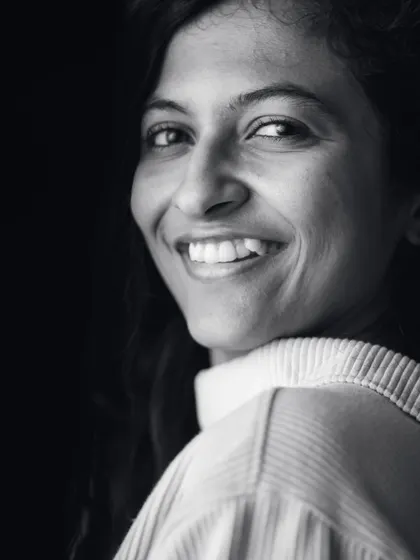 A warm, genuine smile captured in a monochrome portrait. This image shows a softer, more approachable side of my boudoir work, focusing on natural expression.