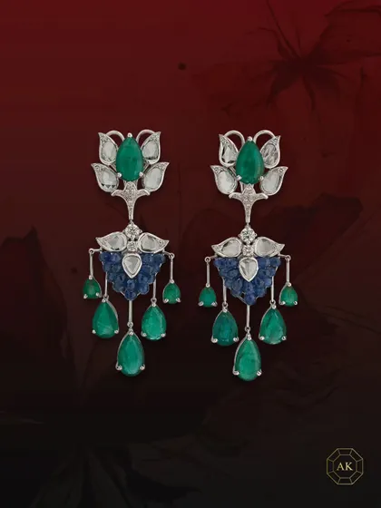 This pair of statement earrings features natural Zambian emeralds, diamonds, and ruby briolettes, elegantly accented by rose-cut diamonds.