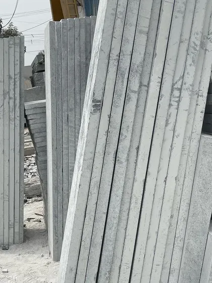 Stacks of long, thin stone slabs.