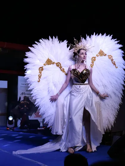 A model poses in the ethereal white angel-winged costume, a highlight of the Memorabilia show.