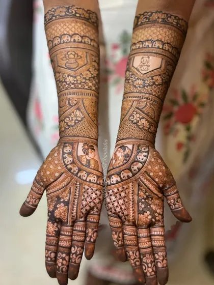 This bridal design features portraits of a couple, surrounded by elephants and traditional patterns. It's a beautiful blend of personalization and classic bridal art.