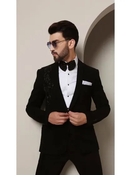 The Galaxy tuxedo, designed for the modern man. The asymmetric cosmic-inspired beadwork on the shoulder adds a touch of futuristic elegance to the classic black-tie silhouette.