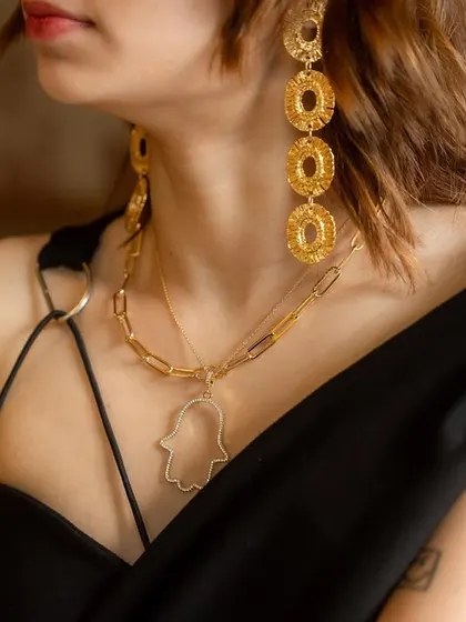 Ordinary is never an option. A model looking chic in my Multi Oval Statement Earrings and a layered necklace look.