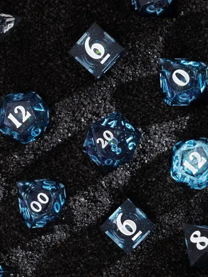 A textured flatlay for Wild Earth Dice. We placed the "galaxy" dice on a bed of black sand, which mimics a starry night sky and adds a tactile element to the composition.