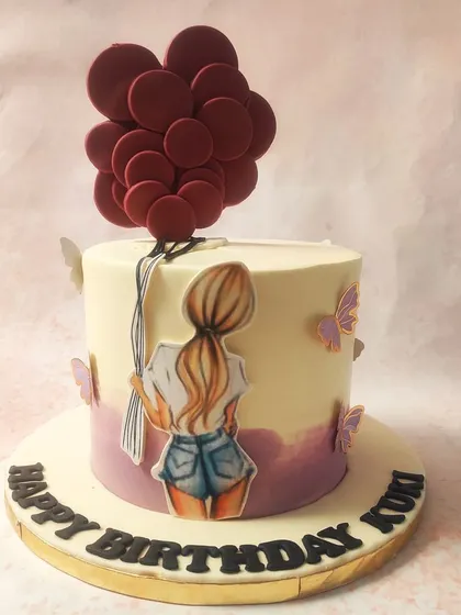 We capture a feeling of carefree joy with this girly balloon cake. A hand-drawn girl holding a large bunch of red balloons is the star, with delicate butterflies fluttering around the base, creating a whimsical and artistic birthday design.