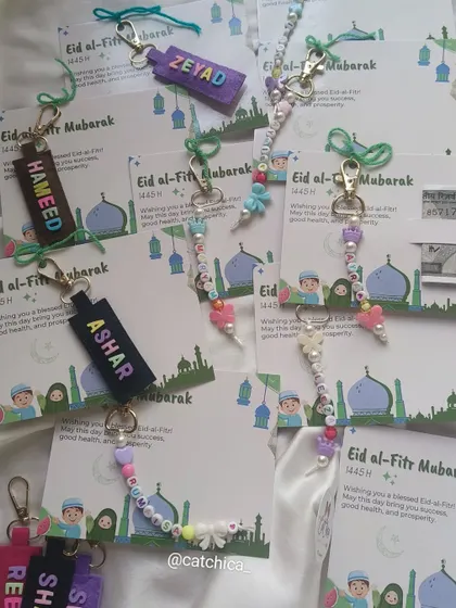 An assortment of our Eidi card gifts, showing both the felt name keychains for boys and the beaded keychains for girls.