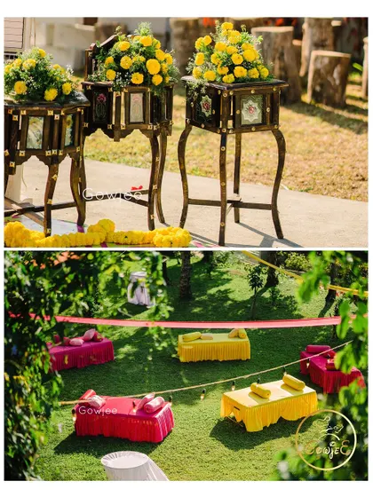 Details of an outdoor Haldi event, showing traditional wooden decor with marigolds and colorful, low seating for guests.