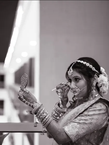 A black and white shot of the bride getting ready, capturing a quiet, behind-the-scenes moment of preparation.