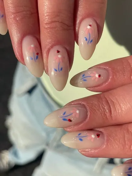 Dainty, hand-painted wildflowers on a sheer nude base. The delicate stems and tiny details give this manicure a whimsical, cottage-core feel.